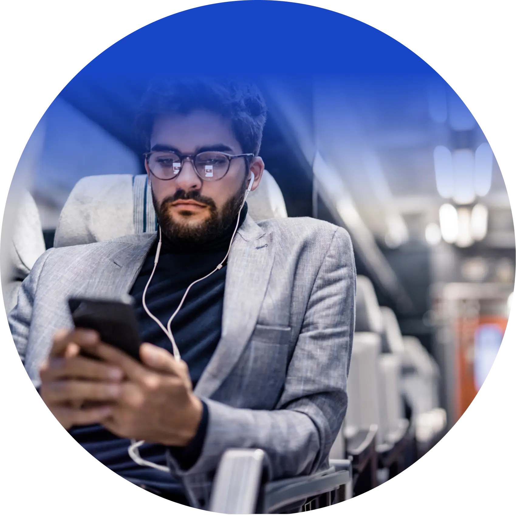 Man wearing glasses and earphones completing an online lesson on his smartphone while traveling.